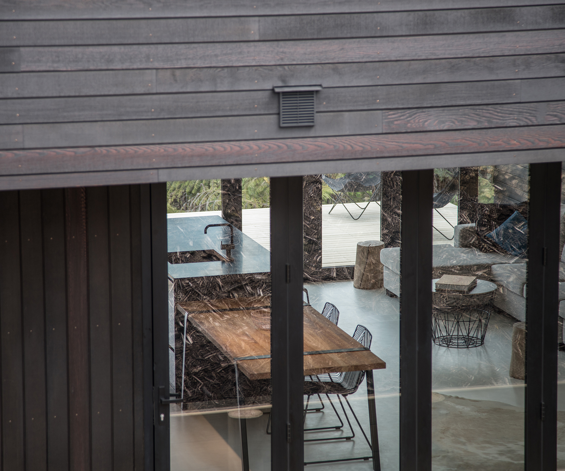 A view through the home's bifold doors from the back yard to the living area. Photograph by Jeremy Toth. 