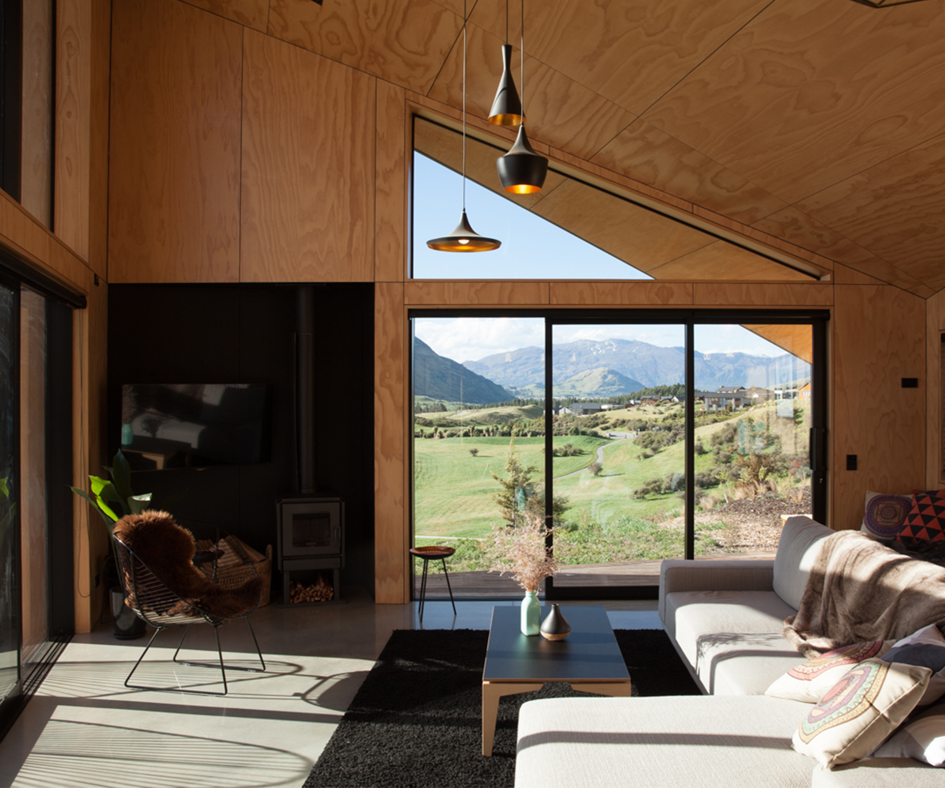 The home's living area is lined in plywood and has carefully framed views north and west.