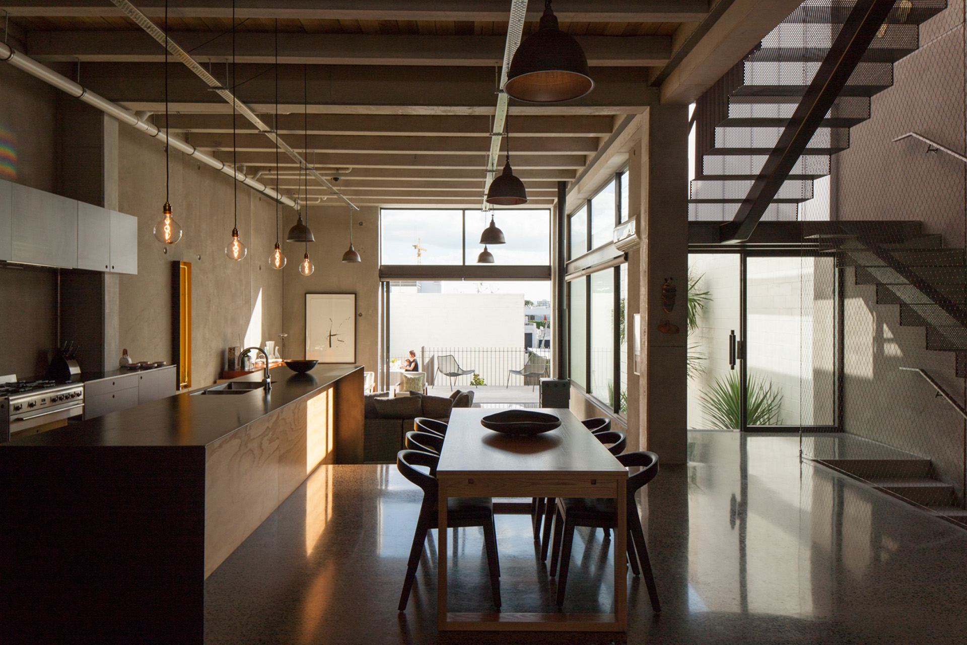 The living area opens onto a terrace that leads to the back lawn. 