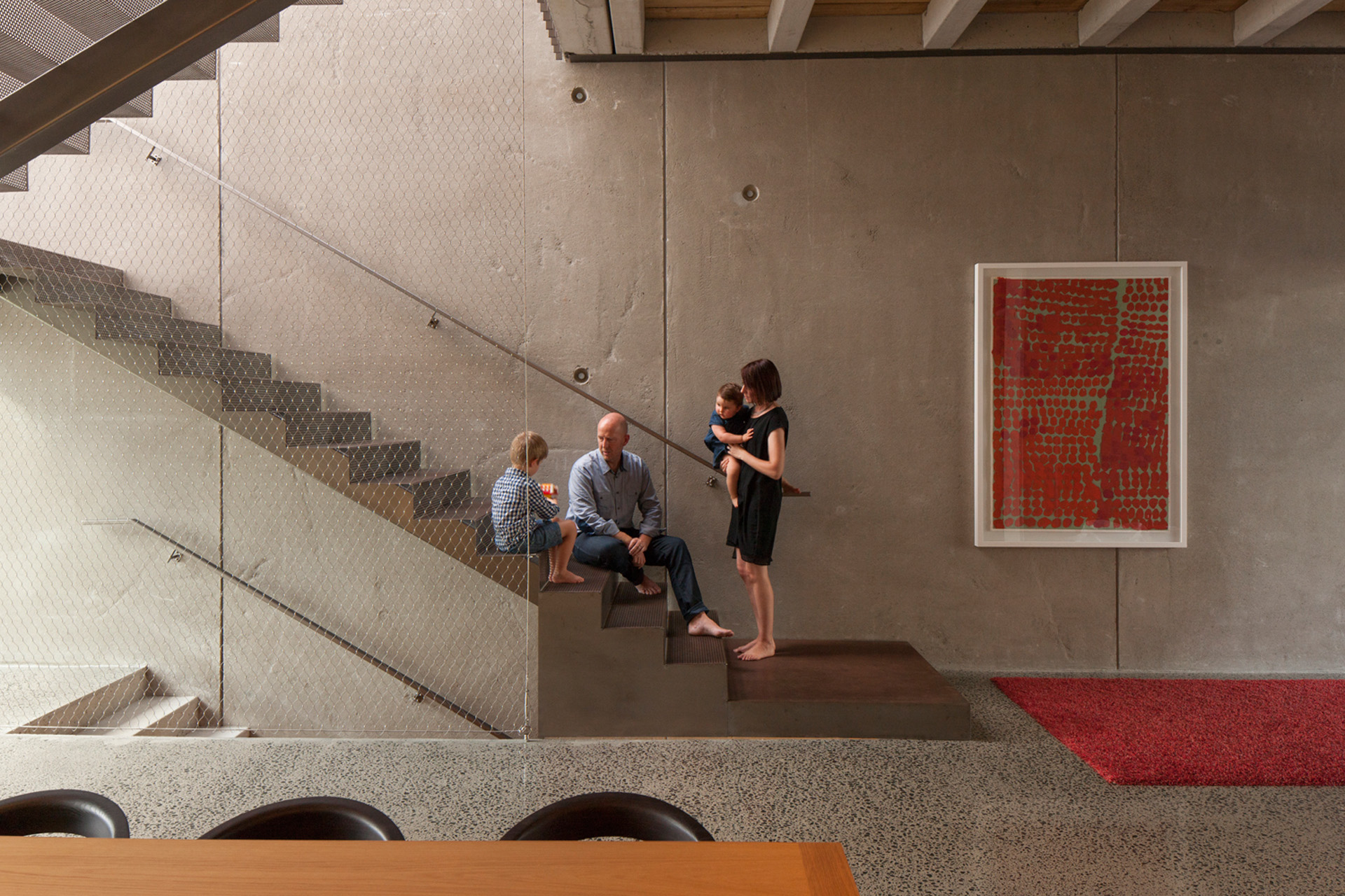 Andrea, Andrew and their children on the home's staircase. 