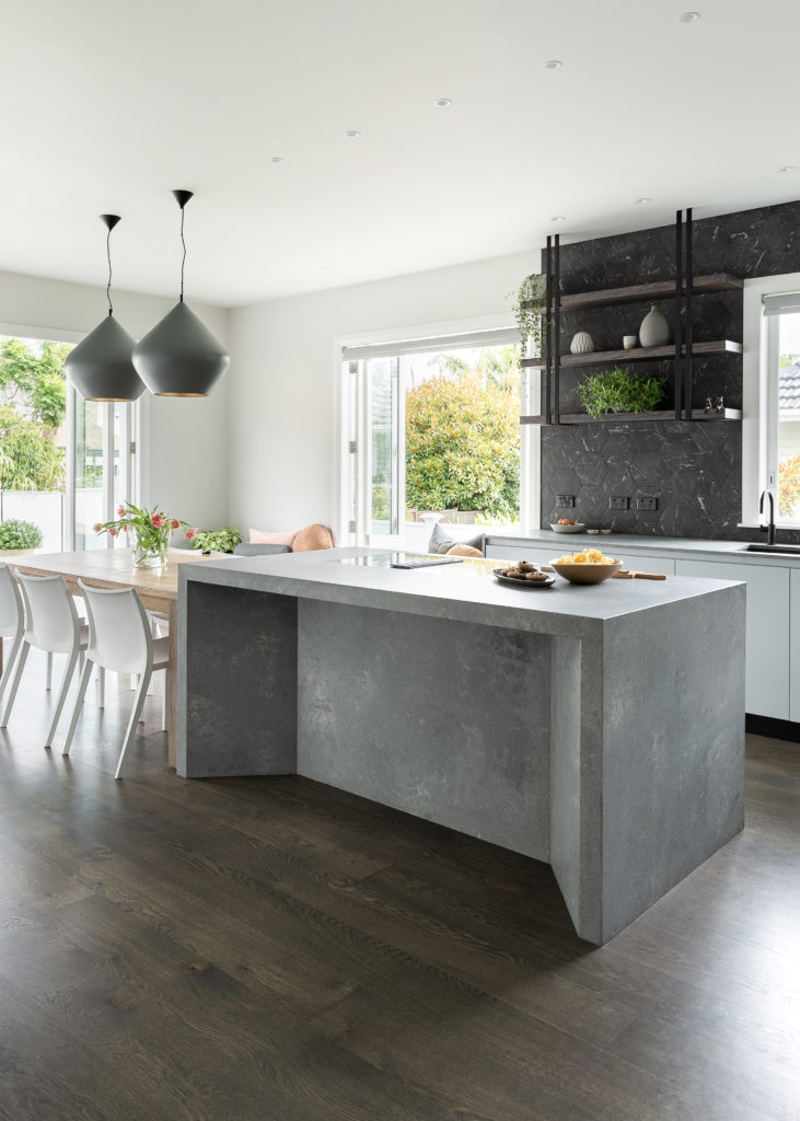 Rudtic kitchen with concrete island and large open windows